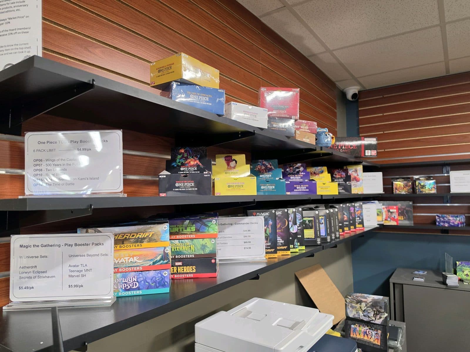 Slatwall shelving stacked with boxed expansions and starter decks.