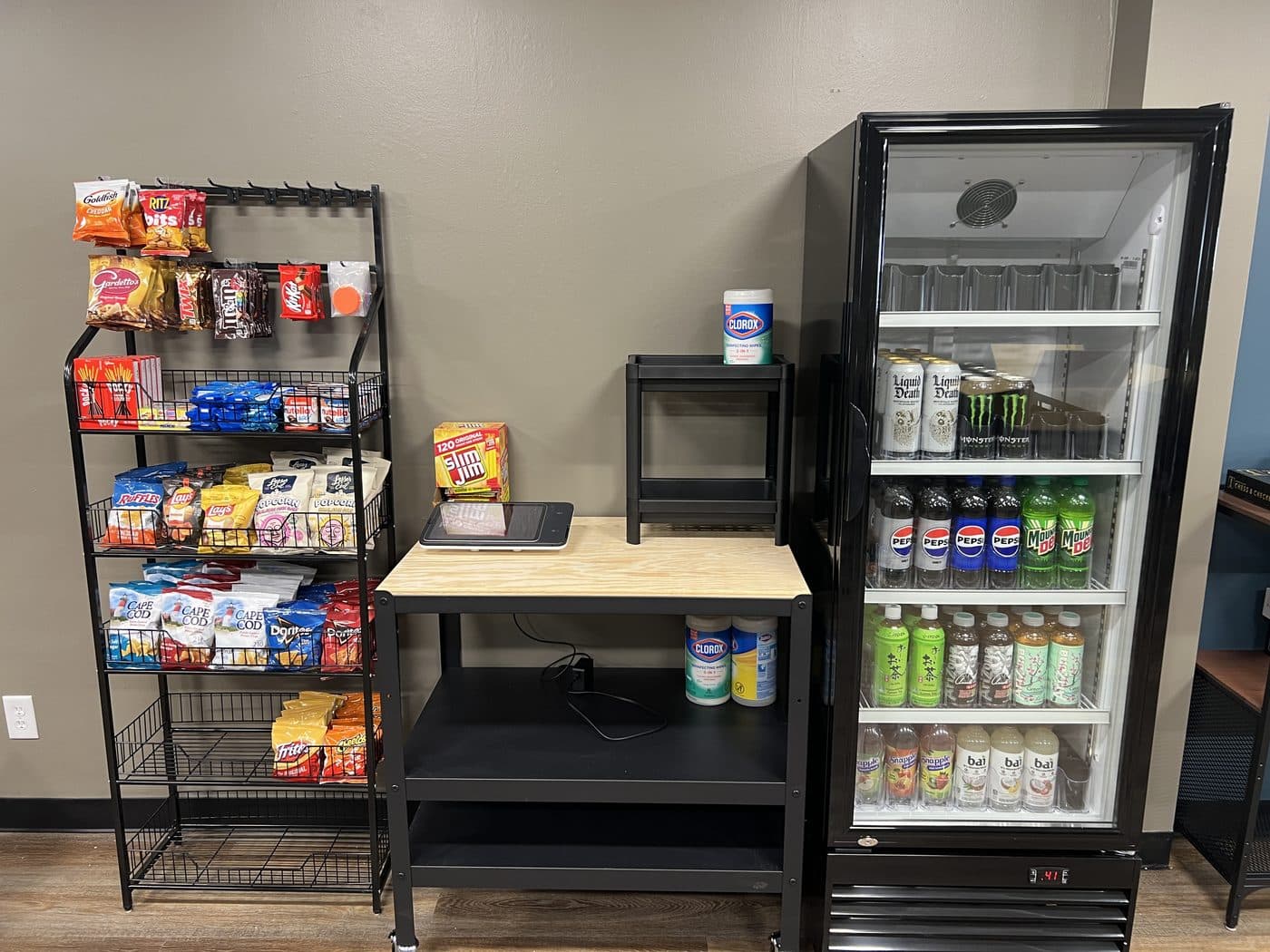 The self-serve kiosk: a snack rack, a microwave, and a glass-front drinks fridge.