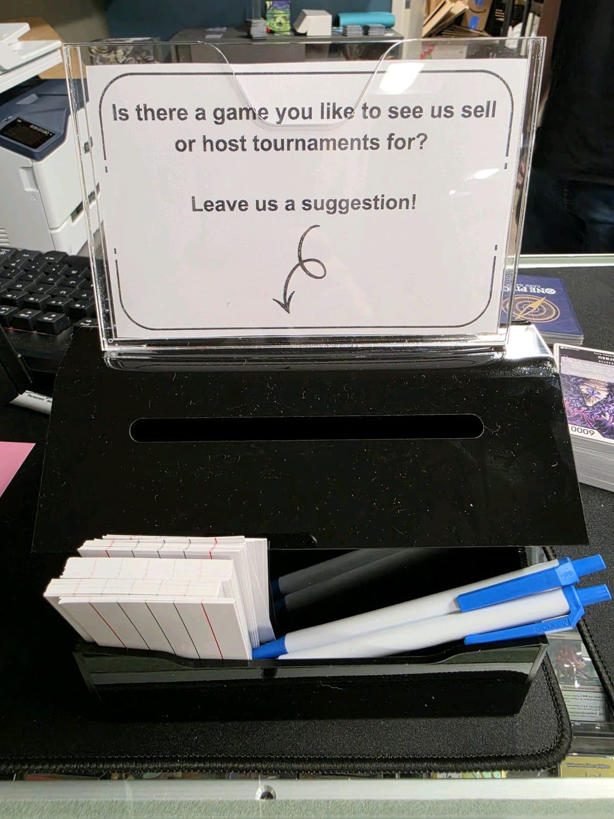 A suggestion box asking which games customers would like the shop to sell or run tournaments for.